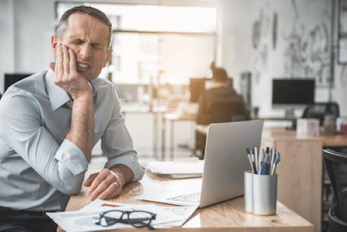 A man in pain having a dental emergency